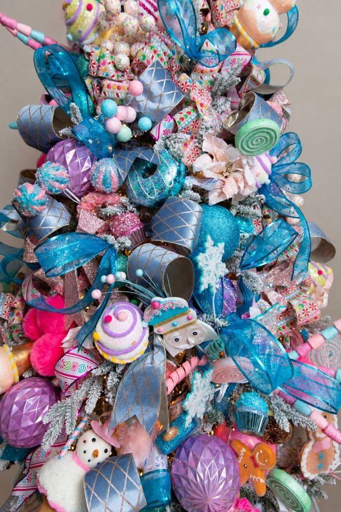 A pastel candy tree with turquoise ribbon, sweets and ornaments