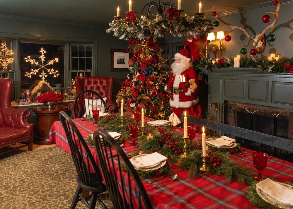 A candlelit tartan table in a green dining room, set beside the tree
