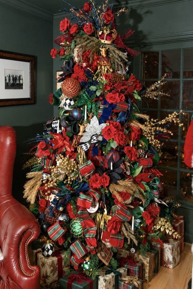 A tall tree filled with tartan ribbon and red roses