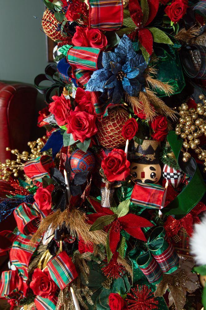 Detail of red roses, tartan ribbon and a nutcracker ornament